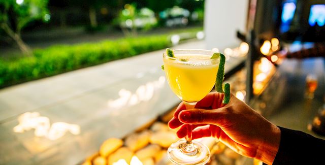 Cocktail sitting on bar overlooking outside entrance